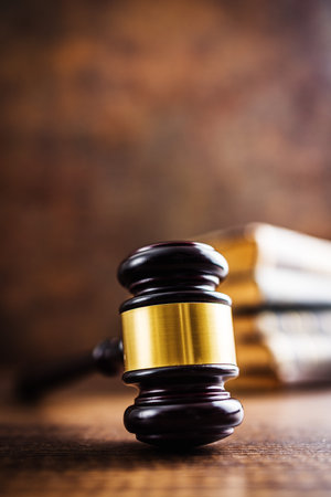 Wooden judge gavel on the wooden table.