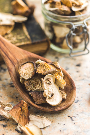 Sliced dried mushrooms in the wooden spoon.の写真素材