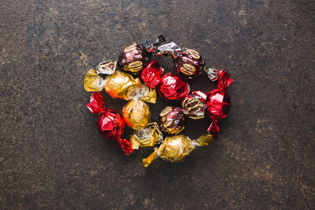 Sweet candy wrapped in foil on the kitchen table. Top view.の写真素材