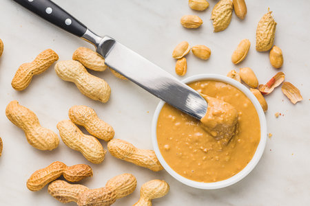 Peanut butter in bowl on kitchen table. Top view.の写真素材