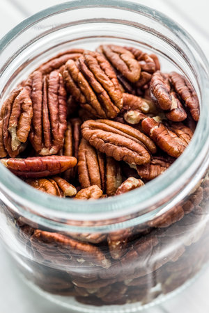 Peeled pecan nuts in a jar.