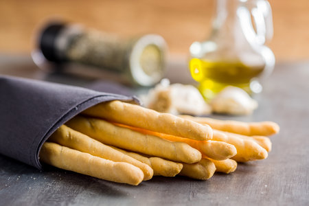 Italian grissini bread sticks seeds on the kitchen table.