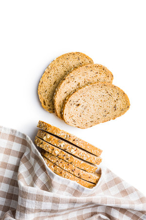 Sliced whole grain bread. Tasty wholegrain pastry with seeds isolated on the white background.