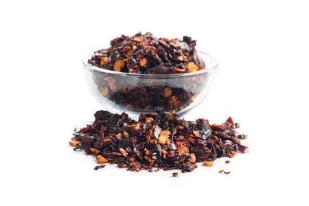 Smoked dry chili pepper flakes. Crushed red peppers isolated on the white background.の写真素材