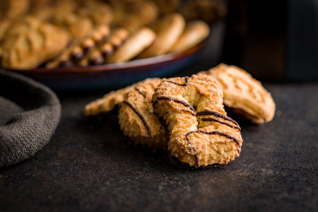 Assorted various cookies. Sweet biscuits on the black table.の写真素材