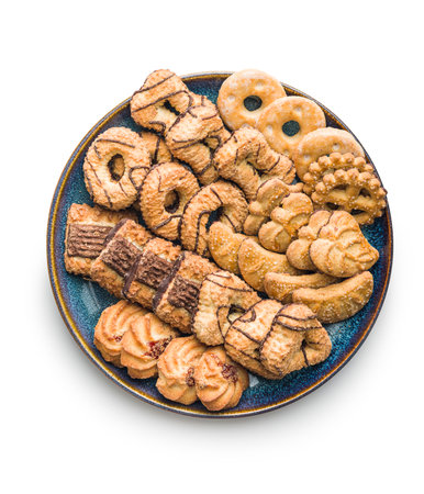 Assorted various cookies. Sweet biscuits on a plate isolated on the white background.の写真素材