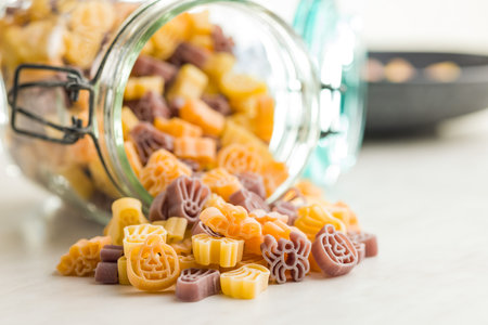 Pasta of various scary shapes. Uncooked Halloween pasta on a kitchen table.の写真素材