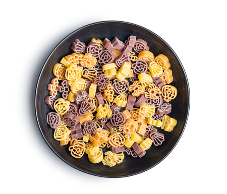 Pasta of various scary shapes. Uncooked Halloween pasta in the plate isolated on white background.の写真素材