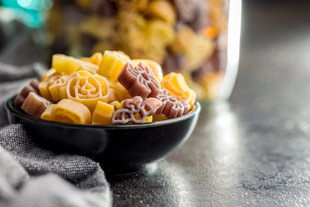 Pasta of various scary shapes. Uncooked halloween pasta in a bowl.の写真素材