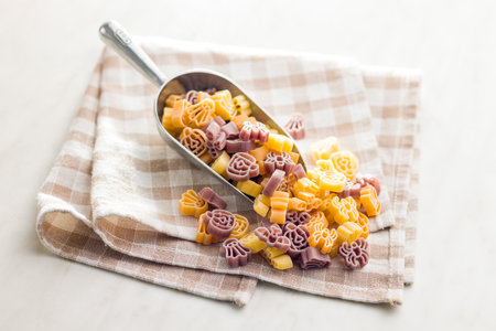 Pasta of various scary shapes. Uncooked Halloween pasta in the scoop.の写真素材