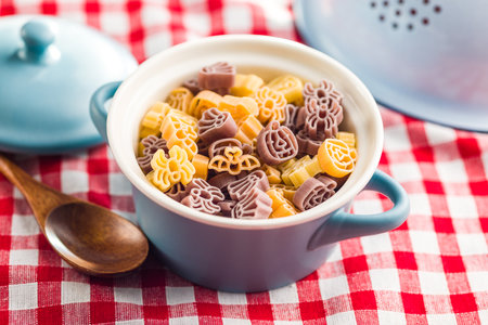 Pasta of various scary shapes. Uncooked Halloween pasta in the pot.の写真素材