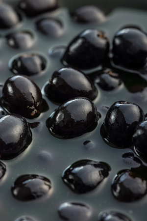 Pitted black olives. Marinated olives in pickle.の写真素材