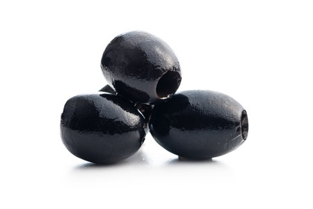 Pitted black olives isolated on the white background.の写真素材