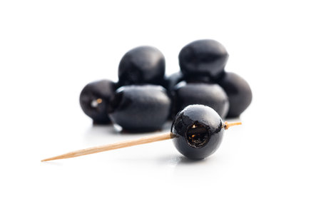 Pitted black olives isolated on white background.の写真素材