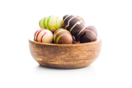 Chocolate easter eggs in a bowl isolated on the white background.の写真素材