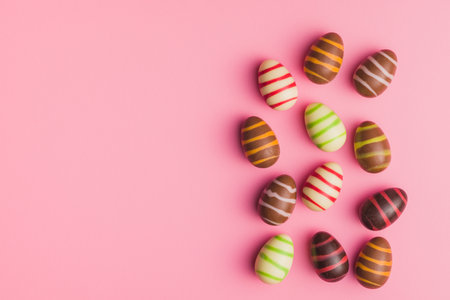 Chocolate easter eggs on the pink background. Top view.の写真素材