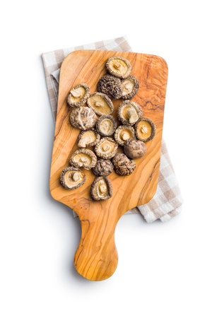 Dried shiitake mushrooms on a cutting board isolated on the white background.の写真素材