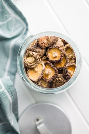 Dried shiitake mushrooms in a jar. Top view.の写真素材
