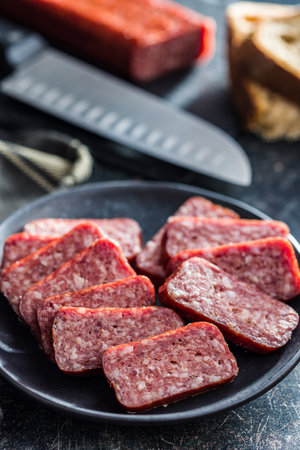 Smoked sausage. Sliced salami on the plate.の写真素材