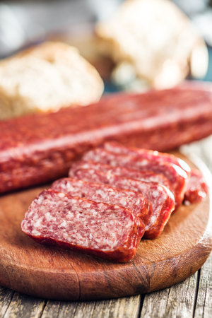 Smoked sausage. Sliced salami on the cutting board.の写真素材