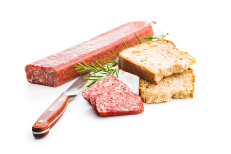 Smoked sausage. Sliced salami and bread isolated on the white background.の写真素材