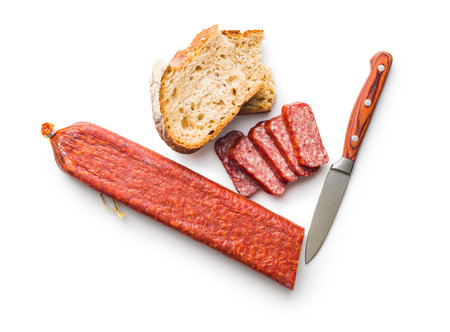 Smoked sausage. Sliced salami and bread isolated on the white background.の写真素材