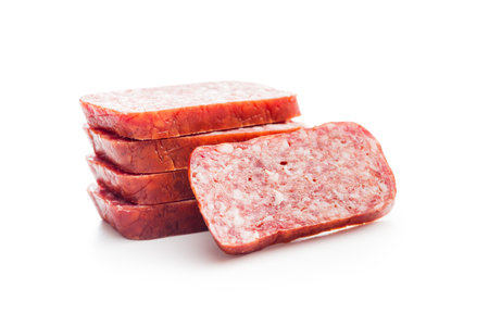 Smoked sausage. Sliced salami isolated on the white background.の写真素材