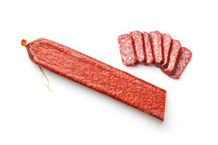 Smoked sausage. Sliced salami isolated on the white background.の写真素材