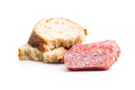 Smoked sausage. Sliced salami and bread isolated on the white background.の写真素材