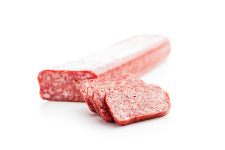 Smoked sausage. Sliced salami isolated on the white background.の写真素材