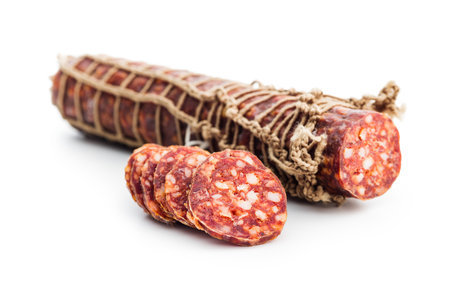 Smoked sausage. Sliced salami isolated on the white background.の写真素材