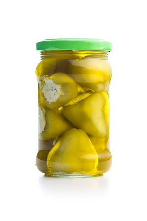 Peppers stuffed with cream cheese in a jar isolated on the white background.の写真素材