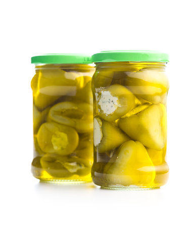 Peppers stuffed with cream cheese in a jar isolated on the white background.の写真素材