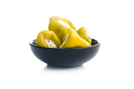 Peppers stuffed with cream cheese in a bowl isolated on the white background.の写真素材