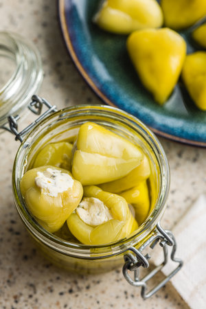 Peppers stuffed with cream cheese in the jar.の写真素材
