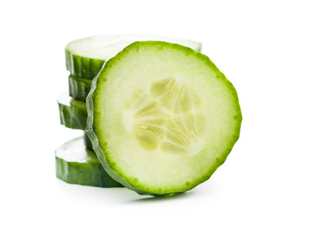 Sliced fresh green cucumber isolated on the white background.の写真素材