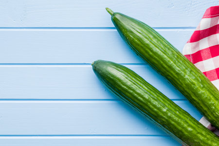 Fresh green cucumbers on the kitchen table. Top view.の写真素材