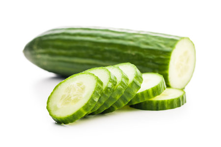 Sliced fresh green cucumber isolated on the white background.の写真素材