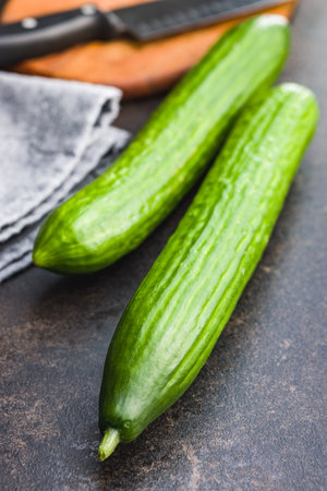 Fresh green cucumbers on the kitchen table.の写真素材