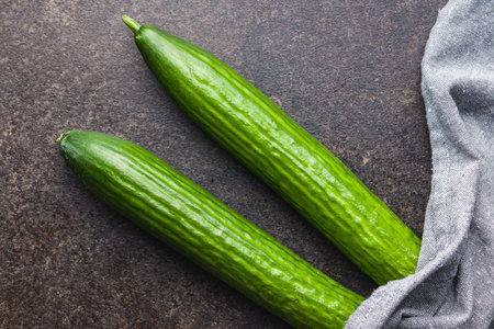 Fresh green cucumbers on the kitchen table. Top view.の写真素材