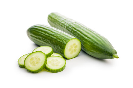 Sliced fresh green cucumber isolated on the white background.の写真素材
