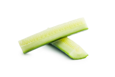Sliced fresh green cucumber isolated on the white background.の写真素材