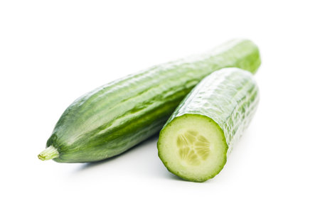 Sliced fresh green cucumber isolated on the white background.の写真素材