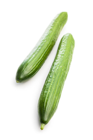 Fresh green cucumbers isolated on the white background.の写真素材