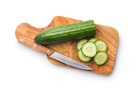 Sliced fresh green cucumber on cutting board isolated on the white background.の写真素材