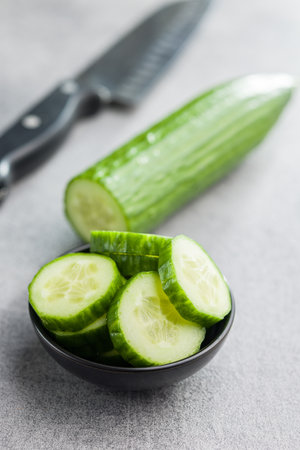Sliced fresh green cucumber in the bowl.の写真素材