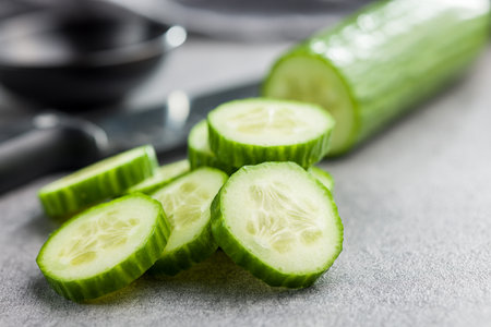 Sliced fresh green cucumber on the kitchen table.の写真素材