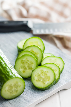 Sliced fresh green cucumber on the cutting board.の写真素材
