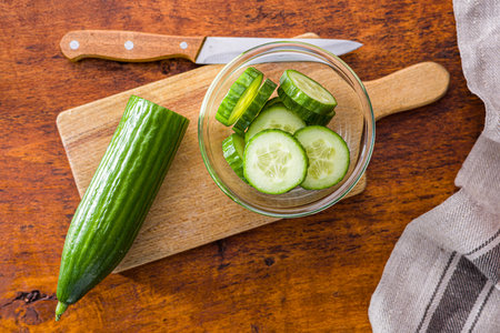 Sliced fresh green cucumber in the bowl. Top view.の写真素材