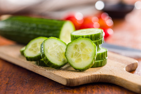 Sliced fresh green cucumber on the cutting board.の写真素材
